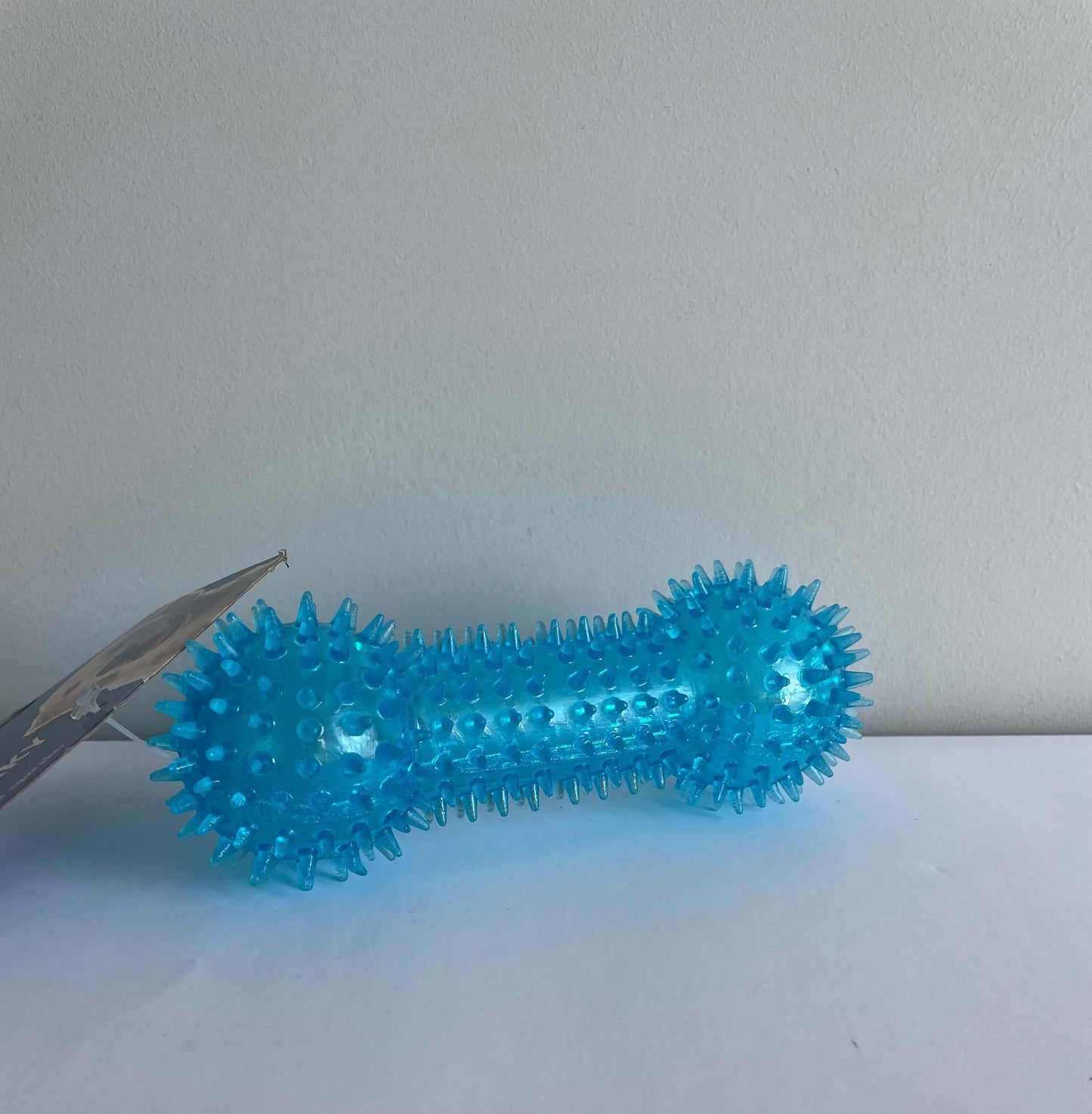 Image of a blue spiky textured boned shaped dog toy