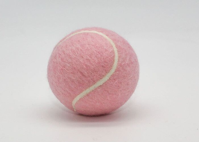 Image of a pastel pink dog tennis ball - Dog toy